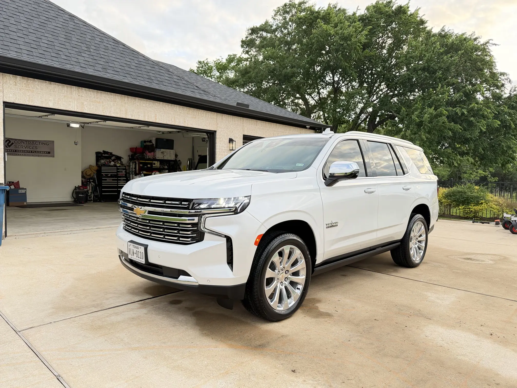 White Chevrolet Tahoe parked in driveway with fresh window tinting Bryan TX