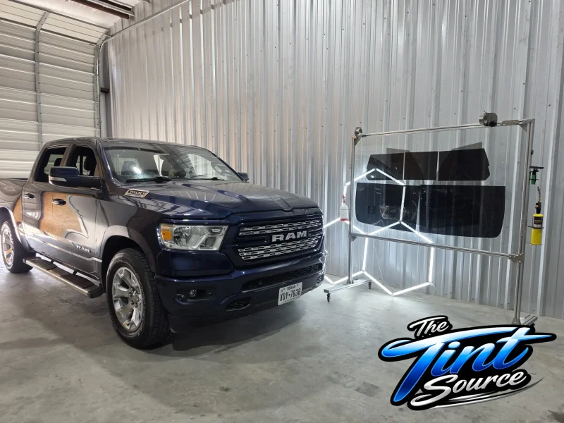 Blue RAM truck inside garage after window tinting College Station area installation