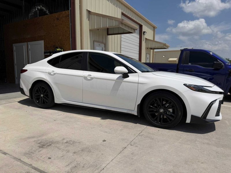 White sedan with dark side window tint completed in the window tinting College Station area