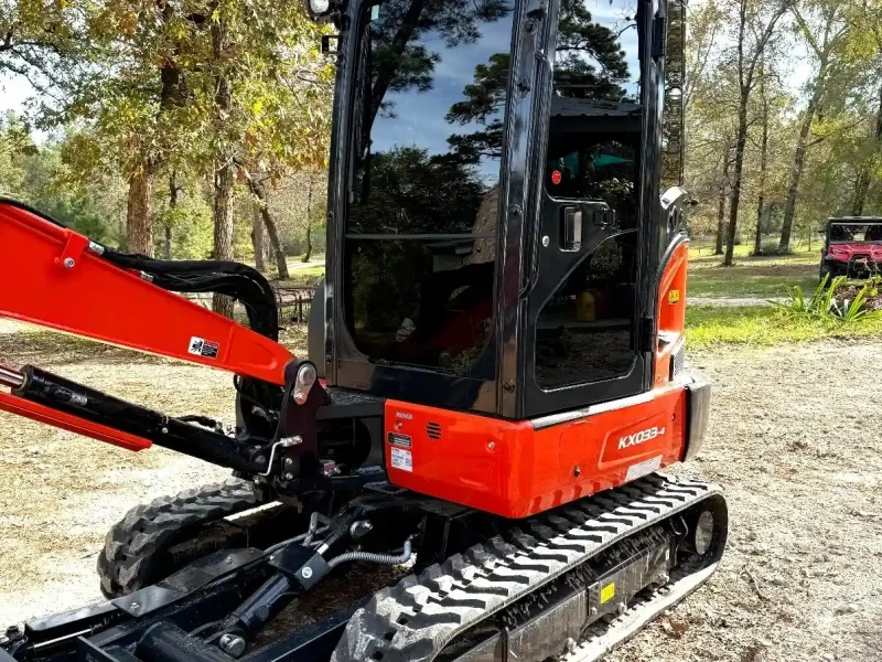 Red mini excavator machinery with glass cabin window tinting Navasota TX
