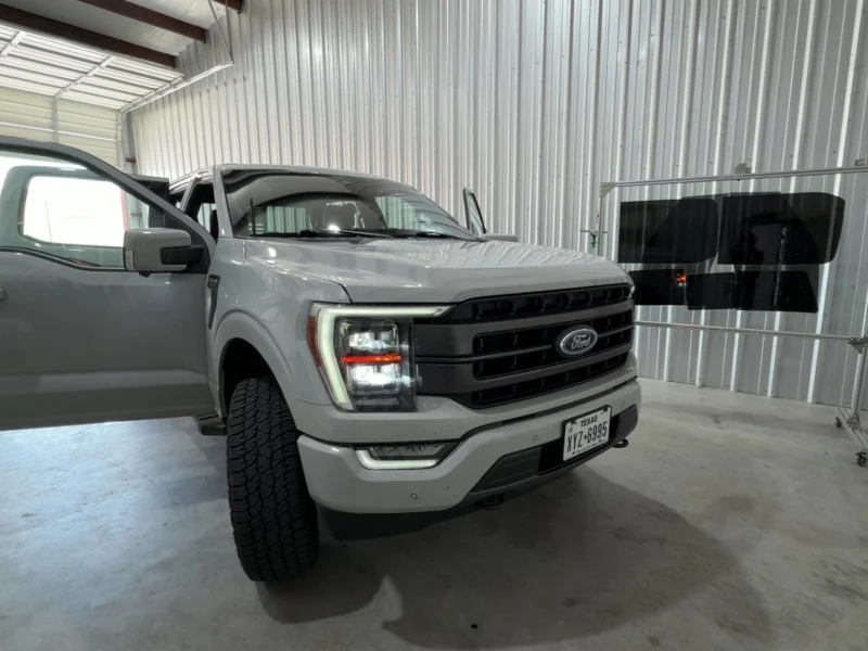 Front view of silver Ford truck inside shop with completed window tinting Navasota TX