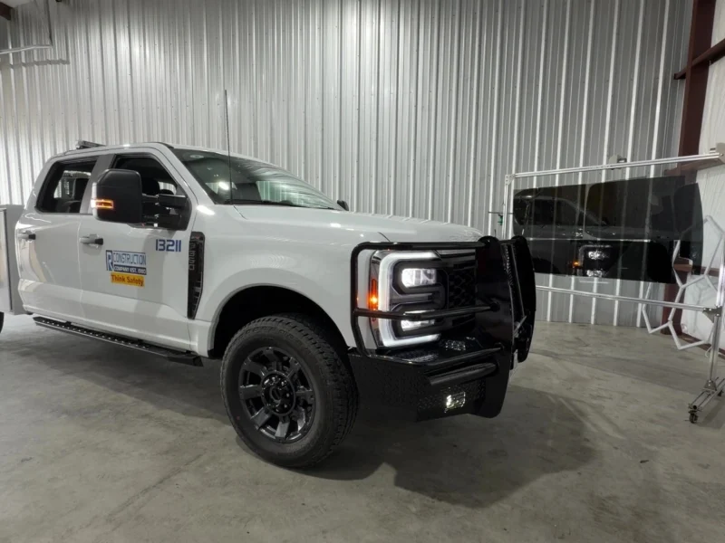White commercial Ford pickup truck parked in shop bay after window tinting Navasota TX