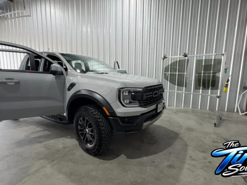 Light gray pickup truck parked in garage bay following window tinting Navasota TX