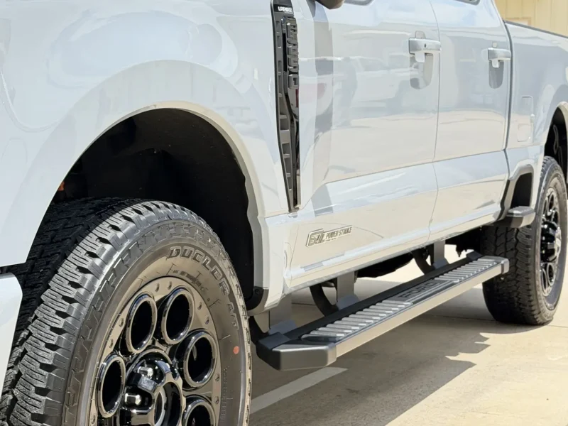 Close-up side profile of silver Ford pickup truck after window tinting Navasota TX